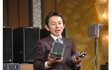 新開発の電源ユニットを見せる山中氏。向かって右の小さい方がが新しい100V電源の画像