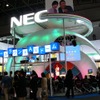 NECブース。中央のステージではビンゴゲームやマジックショーで盛り上がっているの画像