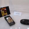 　CEATEC JAPAN 2008のドコモブースでは、プロジェクターを内蔵した携帯電話「プロジェクターケータイ」を展示している。の画像