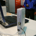 　幕張メッセにて開催されているCEATEC JAPAN 2006にて、ロジテックのPLC対応電力線イーサネットアダプタの実働デモが、三菱マテリアルのブース内にて公開されている。