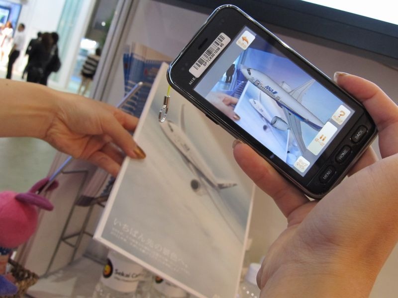 全日空のコンテンツ。パネルにスマートフォンをかざすと3Dの飛行機（ボーイング787）が浮かびあがる。対応端末はAndroid OS 2.2 以上を搭載しているスマートフォン。将来的にはiOSにも対応の予定だという。