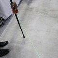 レーザー光を照射する筐体を装着した杖となっており、杖をつくと踏み出し線が照射される（撮影：防犯システムNAVI）